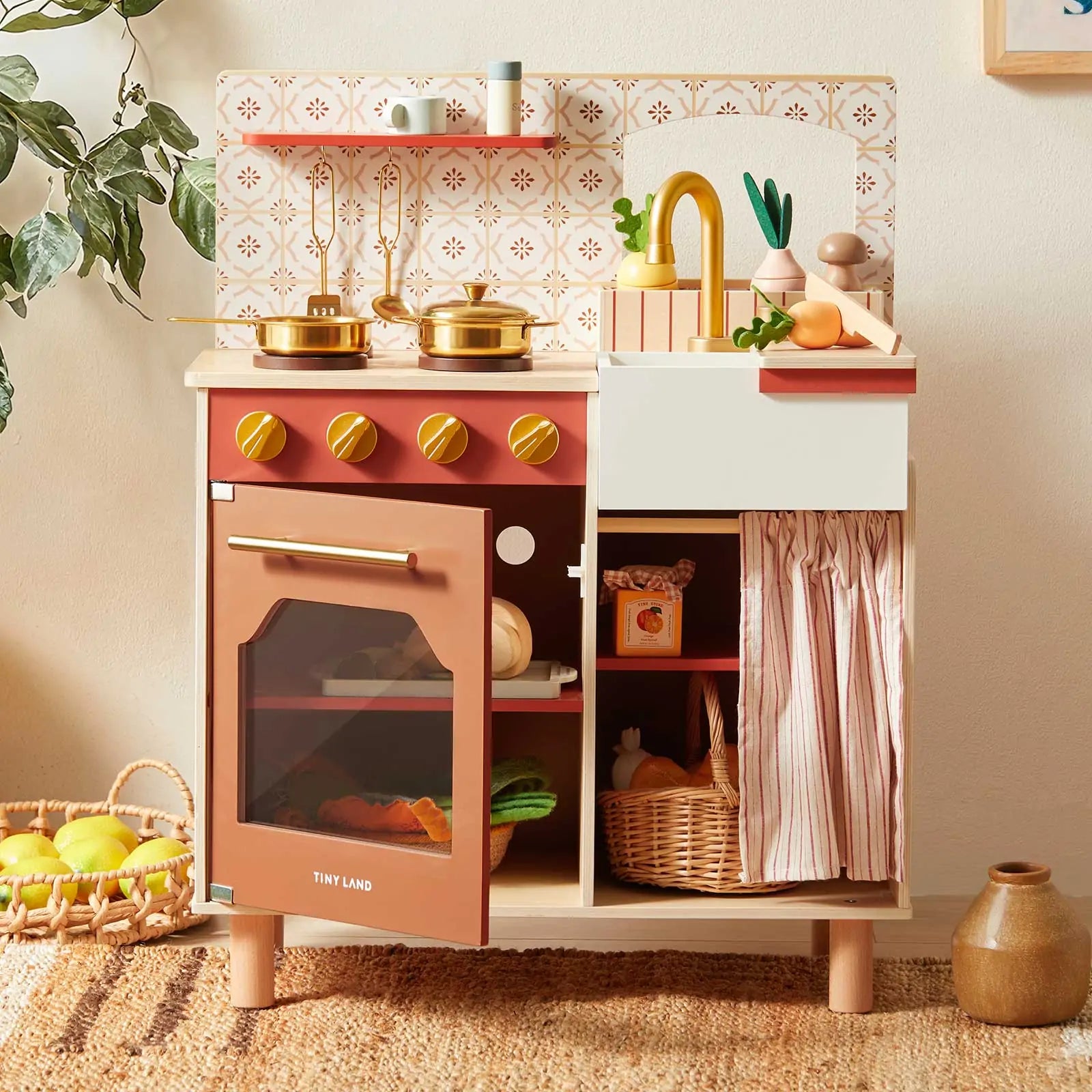 A Mediterranean Play Kitchen is full of play food toy and kitchen accessories in the living room