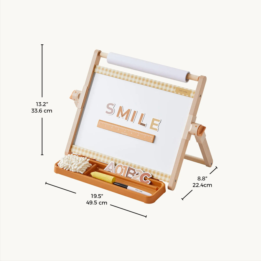 The Tiny LandĀ® Double-Sided Magnetic Tabletop Easel by Tiny Land is a versatile art station featuring an adjustable design with a magnetic whiteboard, built-in ruler, and organizer tray for markers, letters, and an eraser. Measuring 13.2 inches tall, 19.5 inches wide, and 8.8 inches deep, the board displays the word "SMILE.|Oatmeal