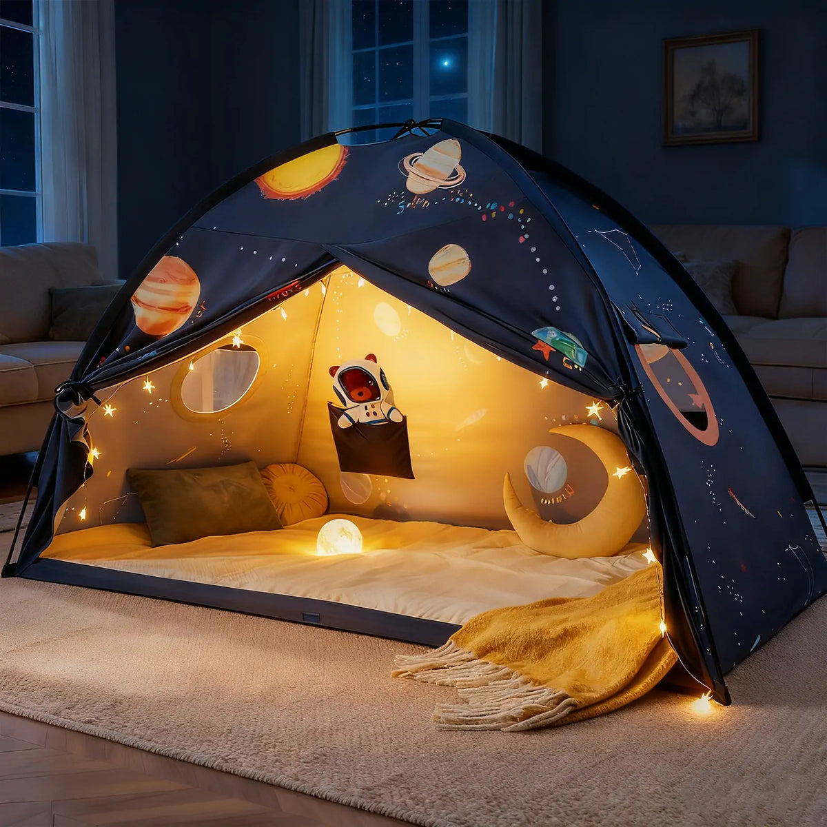 The Tiny Land® SpaceNest Bed Tent by Tiny Land INC features a space-themed design with glowing planets, stars, string lights, cushions, a blanket, and a nightlight, creating a cozy reading nook and sleep canopy for kids.