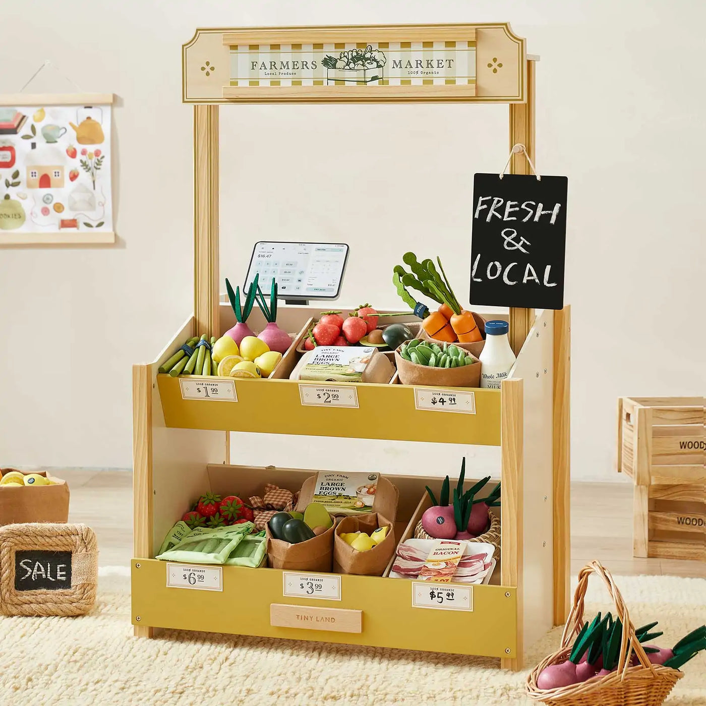 The Tiny Land® Kid's Grocery Store Playset by Tiny Land is a wooden farmers market stand with play fruits, vegetables, baskets with price tags, toy shopping bags, and interactive grocery items—perfect for bright playrooms and pretend play.