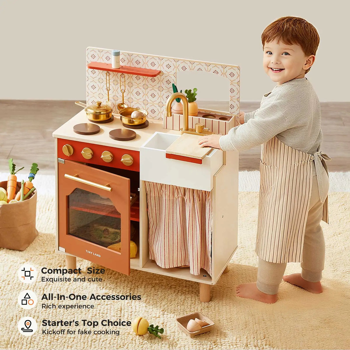 A young child in an apron plays with the Tiny Land® Mediterranean Play Kitchen by Tiny Land, a pastel wooden set featuring pots, utensils, an oven, toy food items, and text showcasing its stylish features.