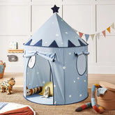 The Tiny Land® Kids Tent – Starry Blue Indoor Tent for Toddlers by Tiny Land stands in a cozy children's room, surrounded by soft toys, cushions, and colorful wall bunting.