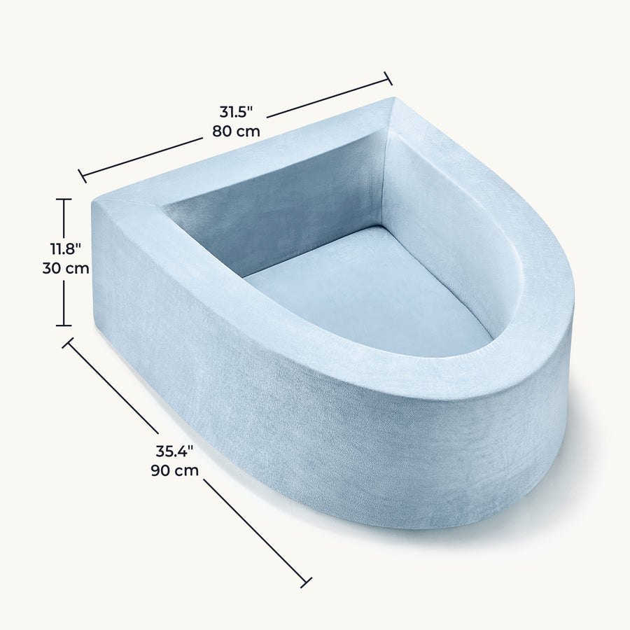 The Tiny Land® PlayNest Soft Foam Ball Pit—measuring 35.4 in (90 cm) long, 31.5 in (80 cm) wide, and 11.8 in (30 cm) high—is a light blue, horseshoe-shaped plush nest inspired by the cozy comfort of a ball pit. Designed by Tiny Land, it offers your pet a soft and inviting space ideal for restful lounging or gentle sensory play at any time of day.|Blue