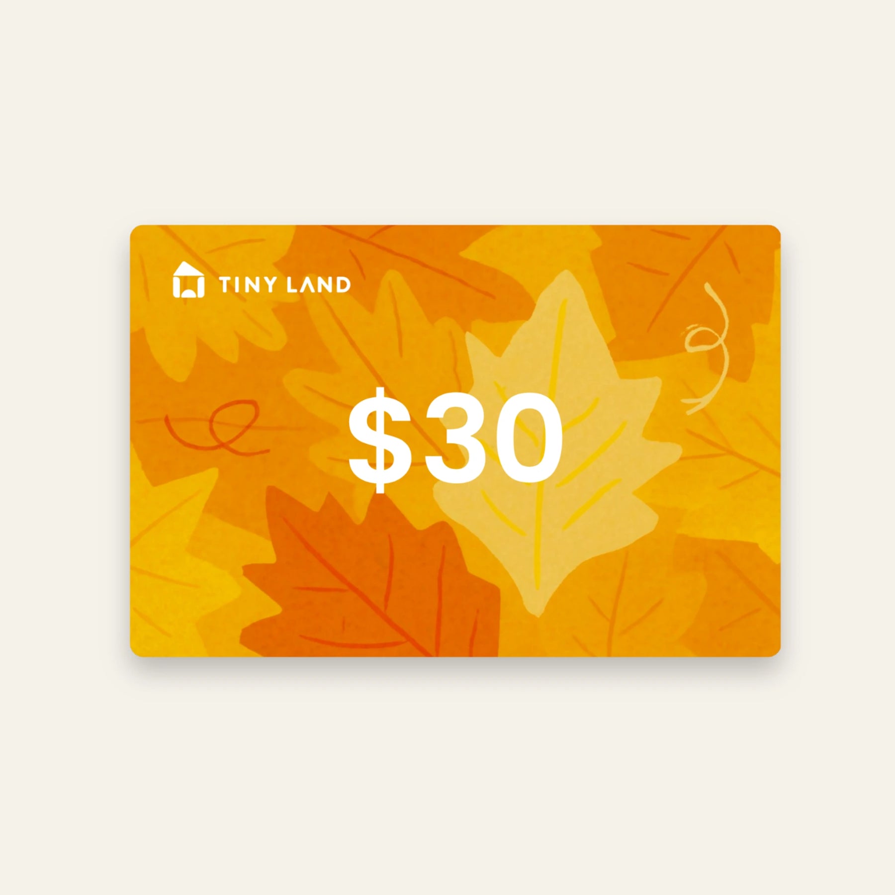 A Tiny Land® Gift Card from Giftnote set against orange and yellow autumn leaves—an ideal online gift for any occasion.
