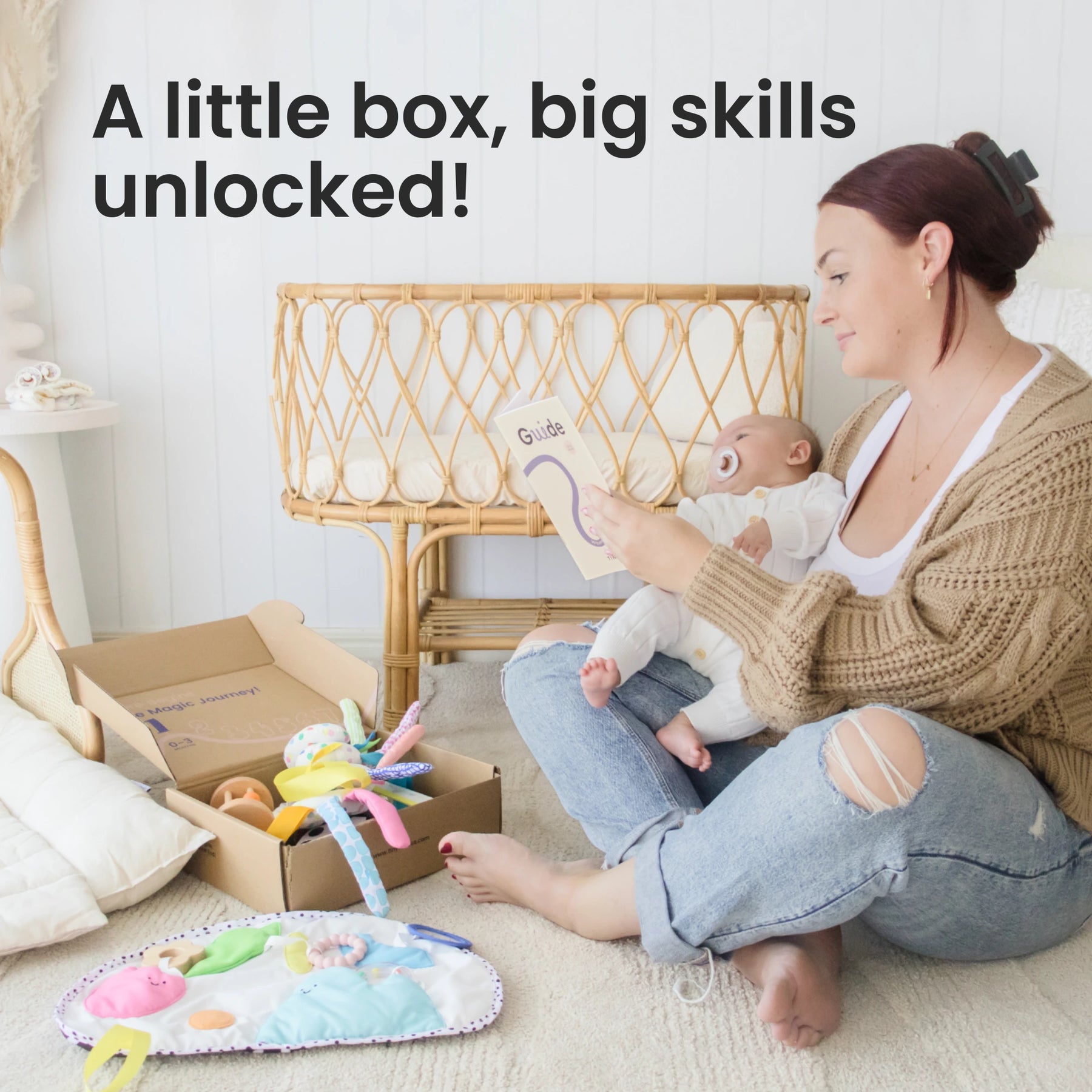 A woman sits on the floor with her baby, reading a guide beside an open box of Tiny Land® Montessori Toys for Newborns (0–3 Months) from Tiny Land Official Store, with a playmat and colorful toys nearby. Text: A little box, big skills unlocked!.