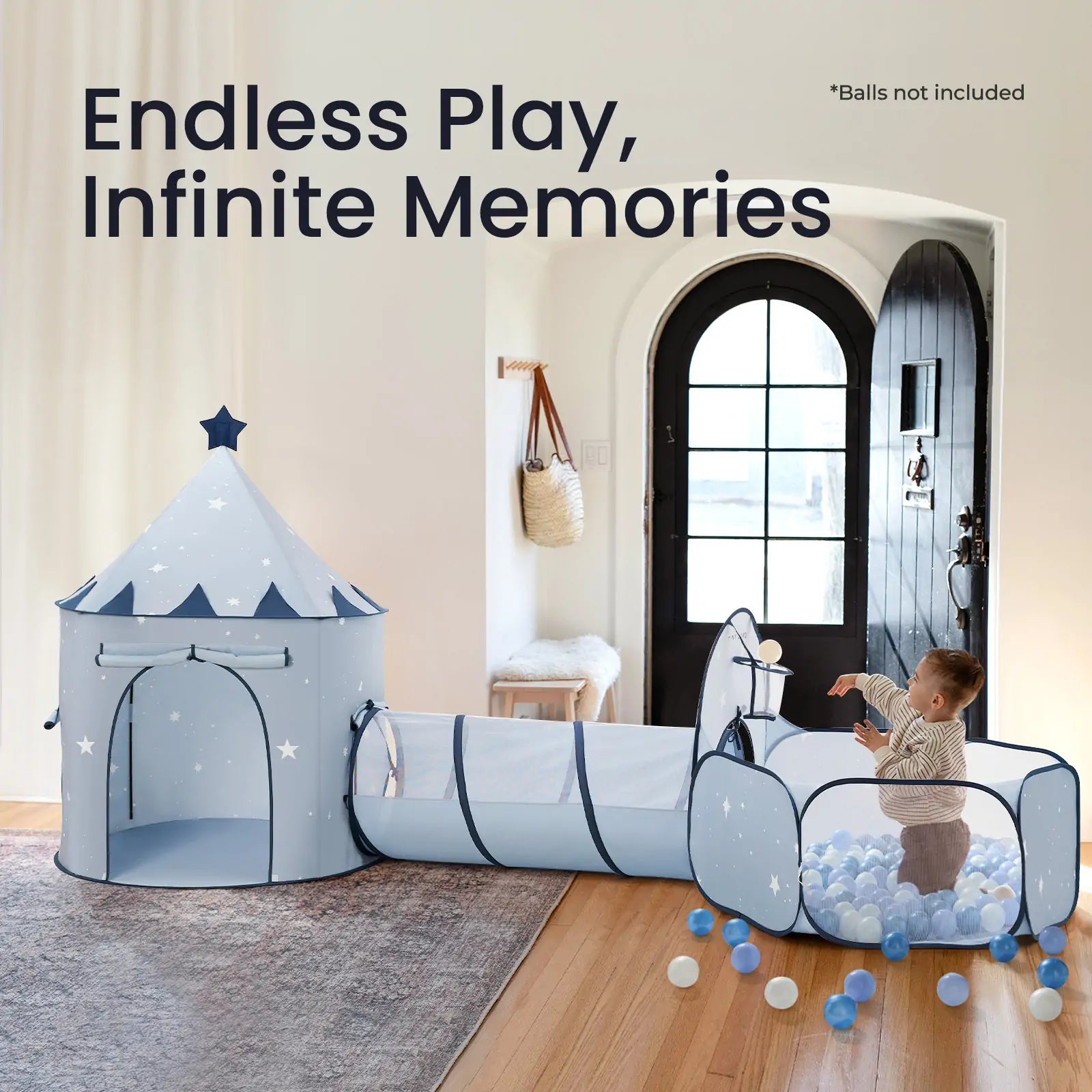 A young child enjoys the Tiny Land® Compact Adventure 3-in-1 Play Tunnel (no balls) in blue inside the living room. Text reads "Endless Play, Infinite Memories." A front door and a bag are visible in the background.
