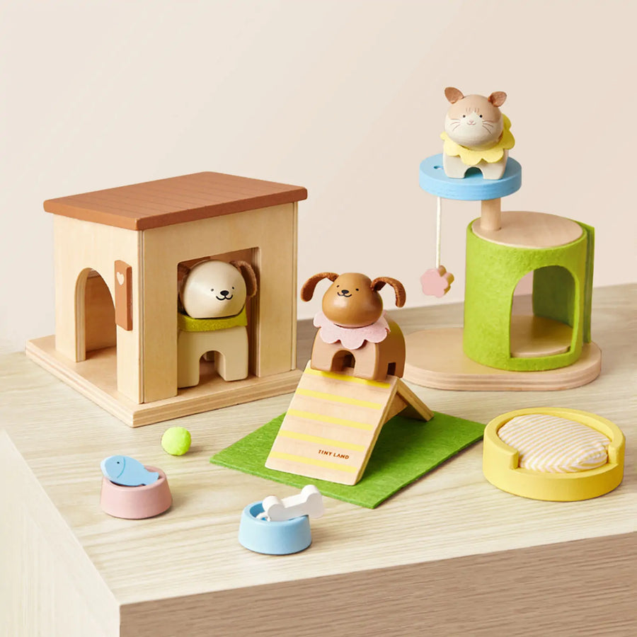The Tiny Land® Happy Urban Paws set by Tiny Land includes a dog, cat, bear, beds, houses, food bowls, and a ramp—perfect for kids’ pretend play and creating a mini pet paradise on a light wooden surface.