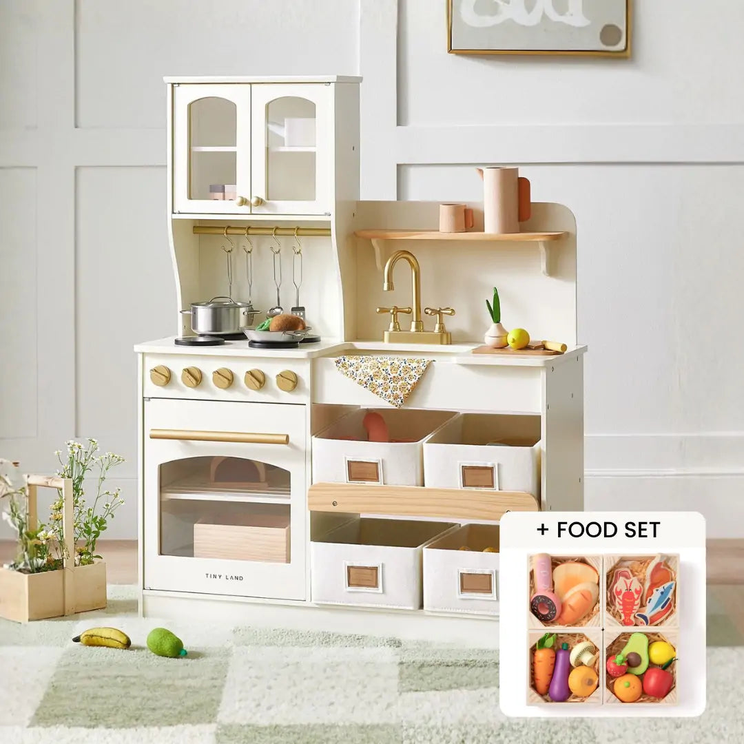 The Tiny Land® Serenity Wooden Kitchen by Tiny Land features drawers, shelves, stove, sink, and hanging utensils on a soft rug. An inset displays the colorful Wooden Food Set with toy fruits, vegetables, and bread for pretend play adventures.