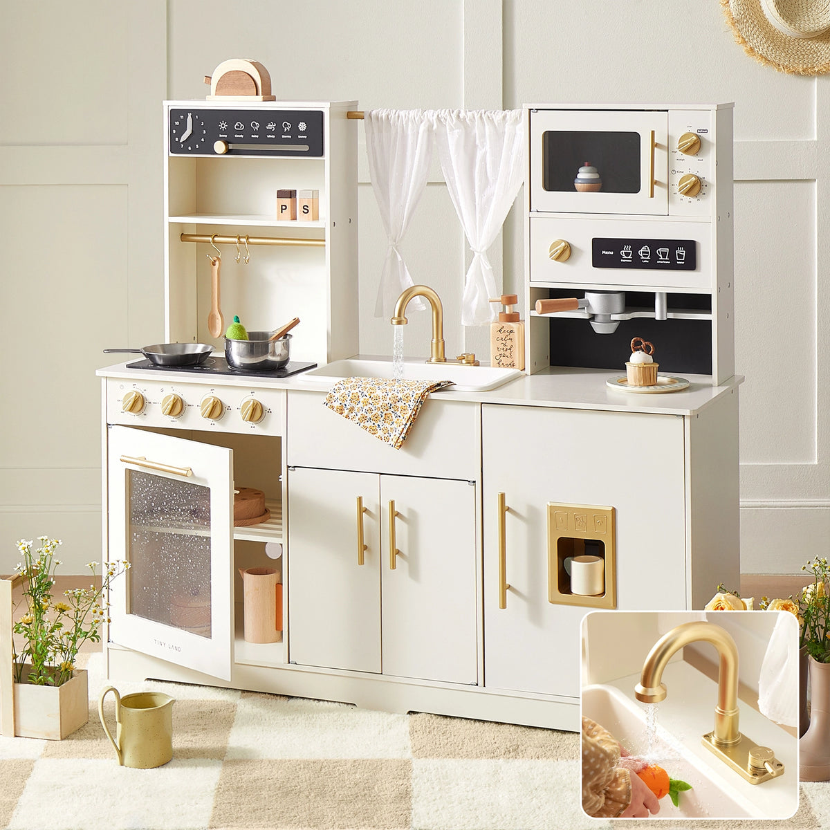 The Tiny Land® Play Kitchen with Running Water – Iconic Aqua Kitchen in Cream features a stove, oven, sink with gold faucet, cupboards, shelves, toy food, accessories, plants, and a cozy rug—perfect for pretend play.