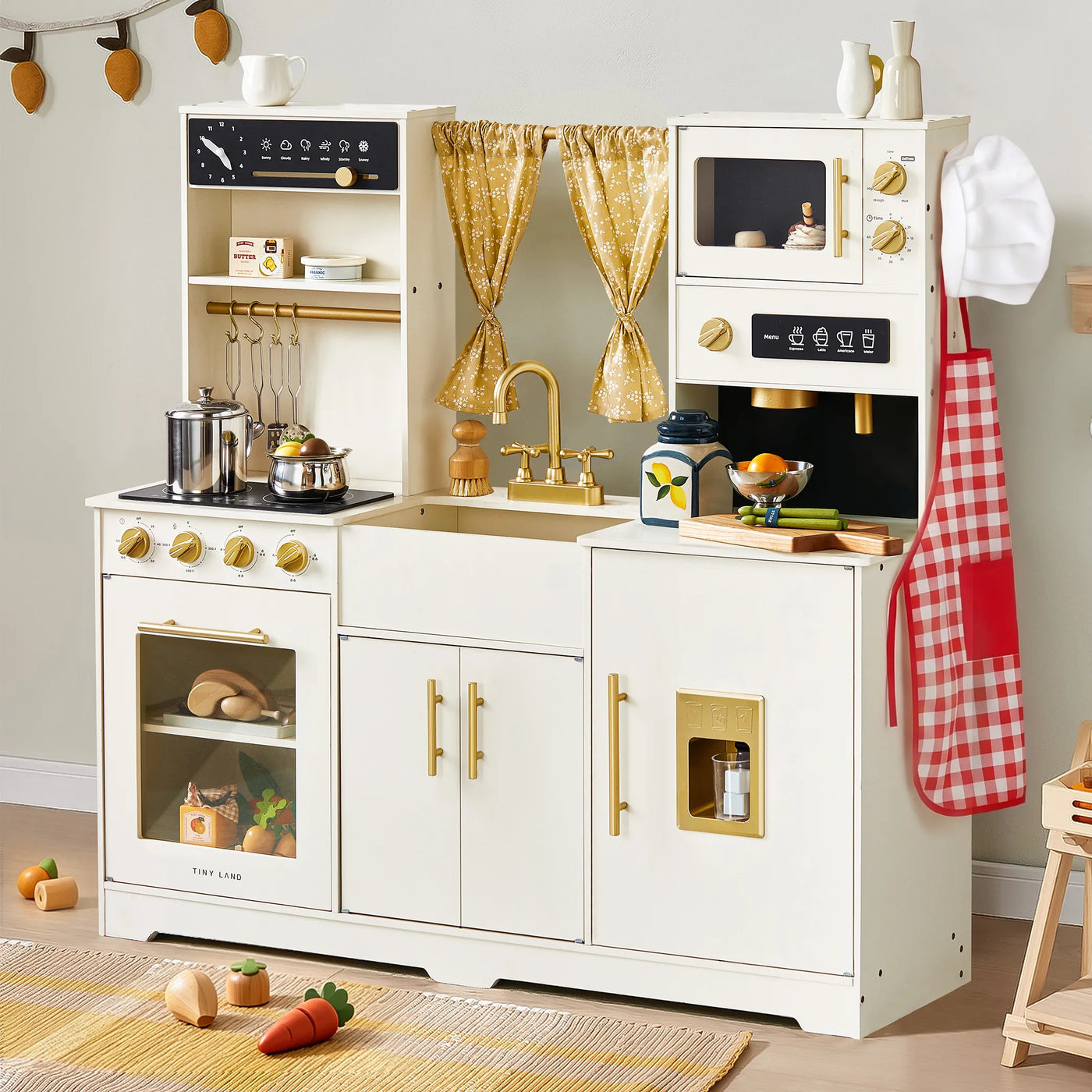 The Tiny Land® Iconic Wooden Play Kitchen by Tiny Land is a cream-colored pretend cooking set for kids, featuring toy appliances, cookware, play food, utensils, an apron, chef hat, and decorative yellow curtains.