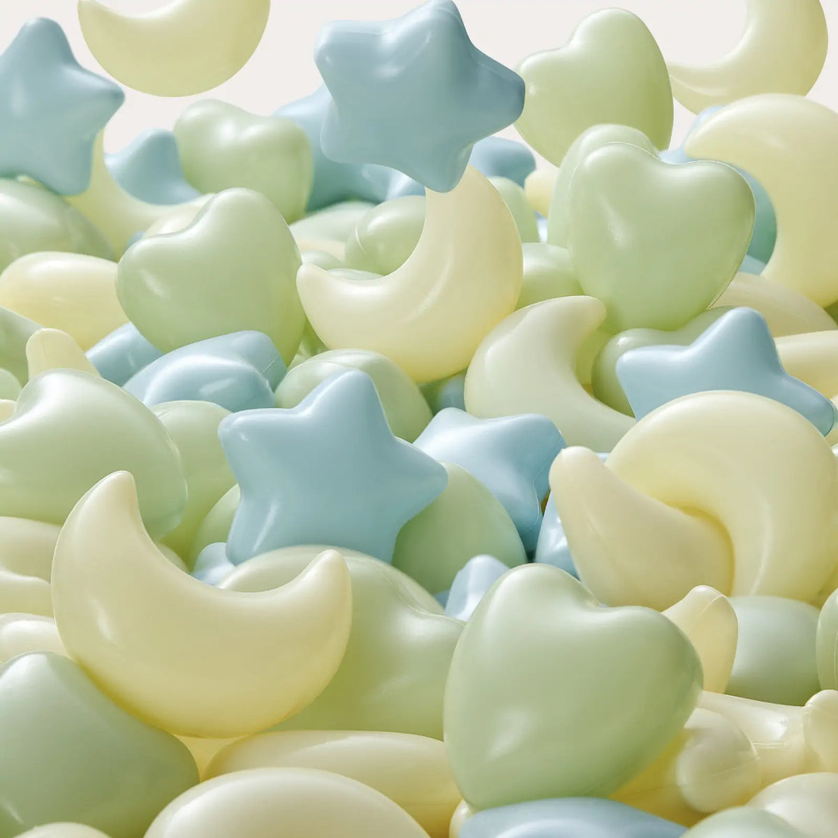 The Tiny Land® Green Adventure 3-in-1 Play Tunnel & Fun-Shapes Ocean Ball Set features moon-, star-, and heart-shaped green, blue, and yellow balls with a smooth, glossy finish for a whimsical, playful experience.|Fun-Shapes