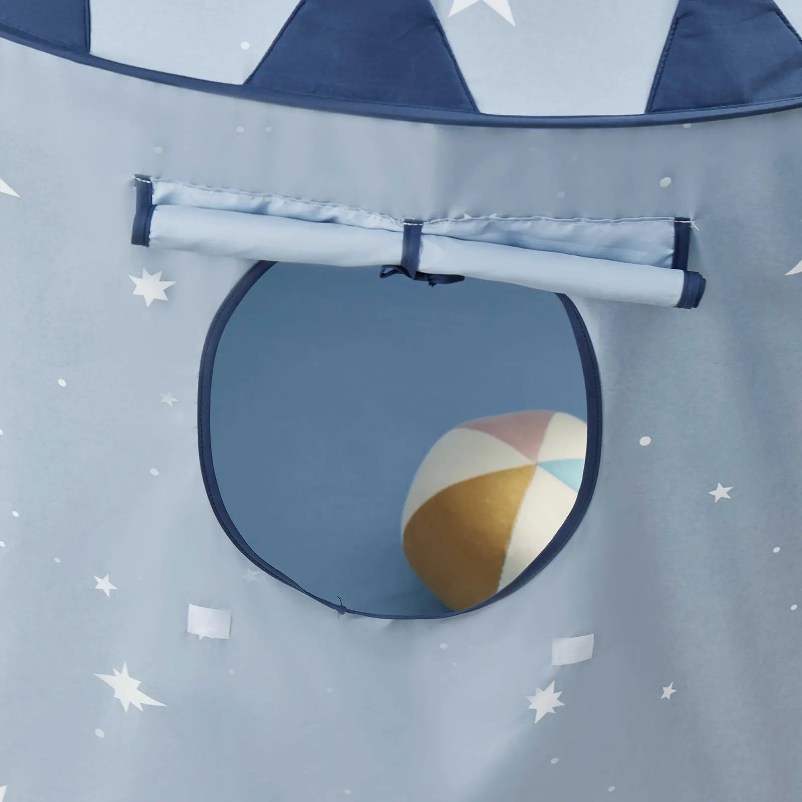 A multi-colored beach ball is visible through the round window of the Tiny Land® Kids Tent – Starry Blue Indoor Tent for Toddlers, decorated with stars and moons.
