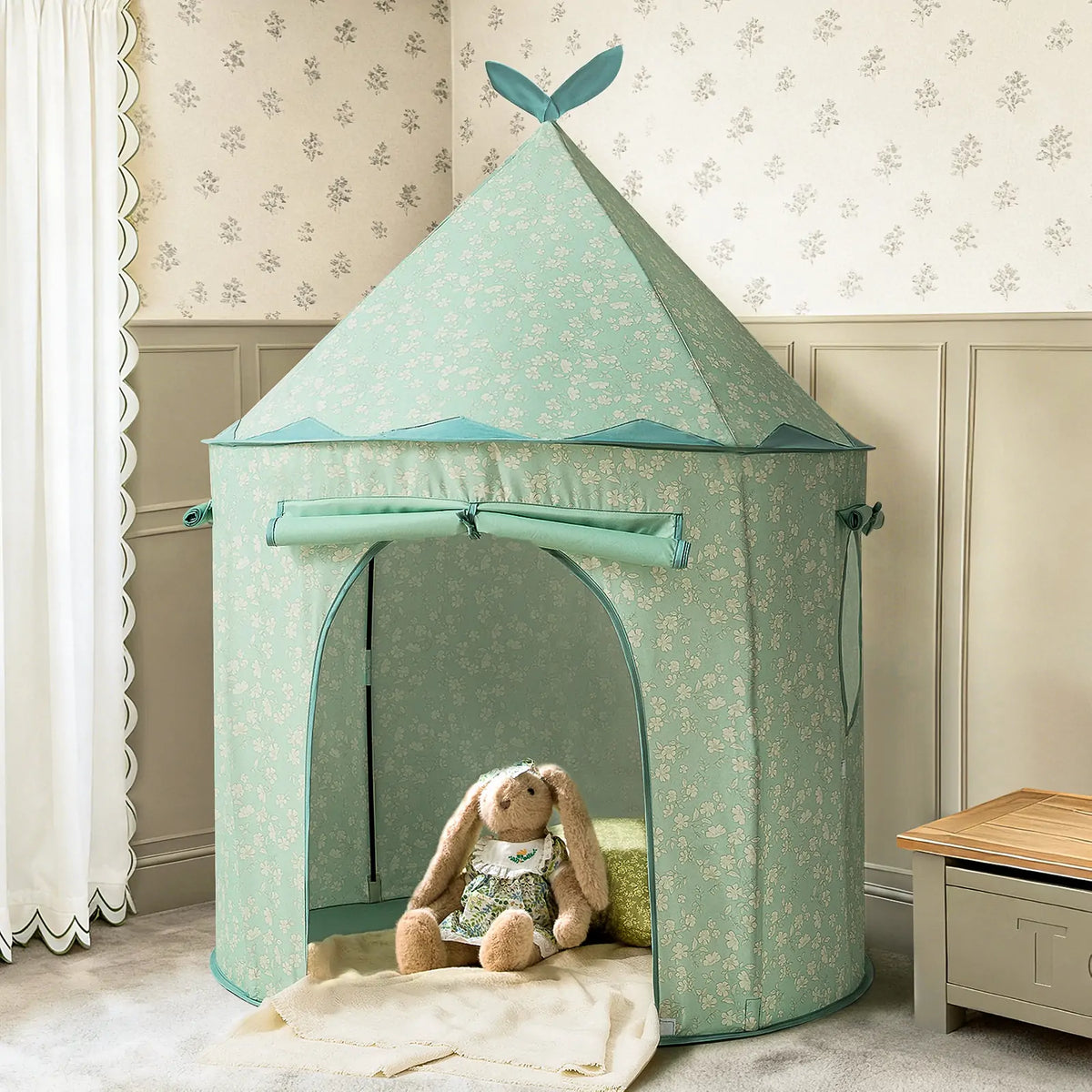 The Tiny Land® Tiny Sprout Castle Tent by Tiny Land, featuring a floral light blue design, stands in a cozy room with a plush rabbit doll inside and a soft rug at the open entrance for playful fun.|green