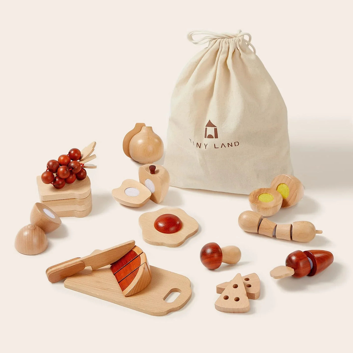 The Tiny Land® Mystery Surprise Box includes premium wooden toy foods—fruits, veggies, cheese, egg, bread—a toy knife, cutting board, and a Tiny Land cloth bag. Just like unboxing a real Tiny Land surprise! Displayed on a light background.