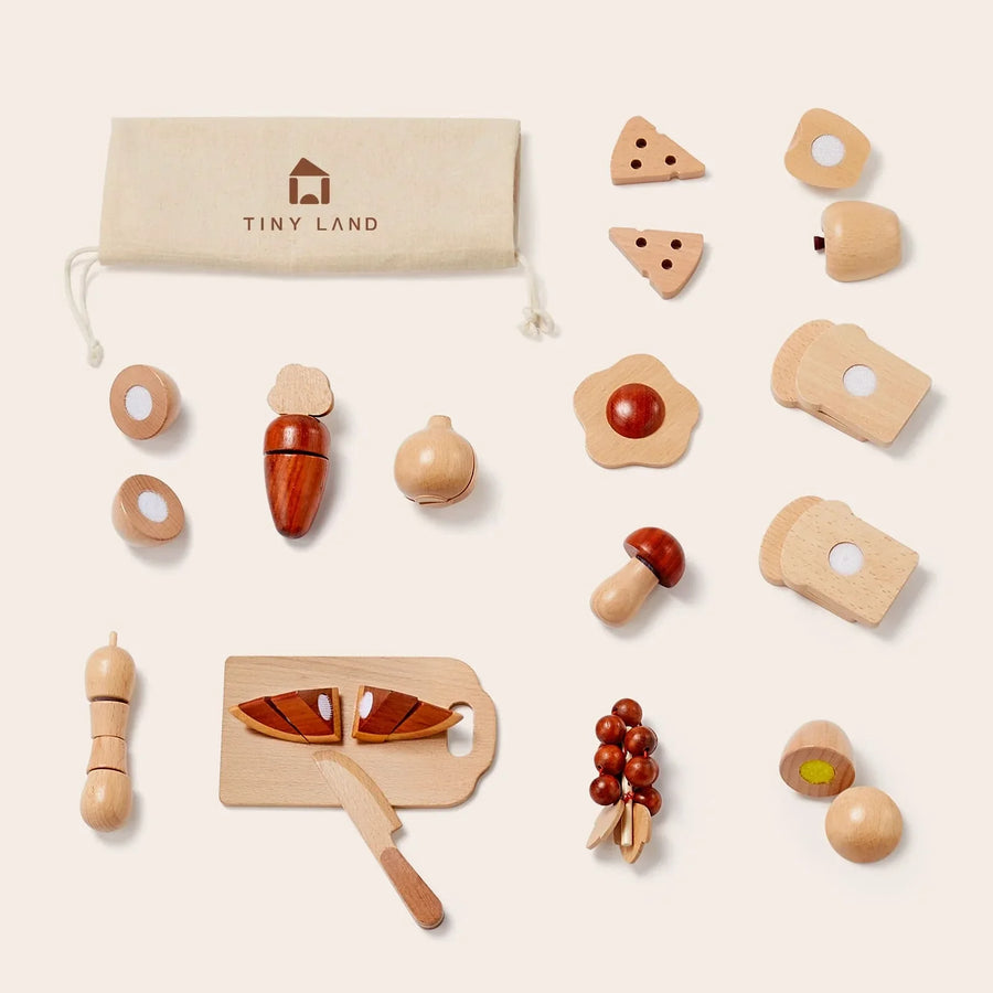 The Tiny Land Play Food set features wooden cut and play kitchen accessories, including fruit, veggies, cheese, bread, a knife, and cutting board—all in a storage pouch labeled Tiny Land® for toddlers’ realistic pretend play.