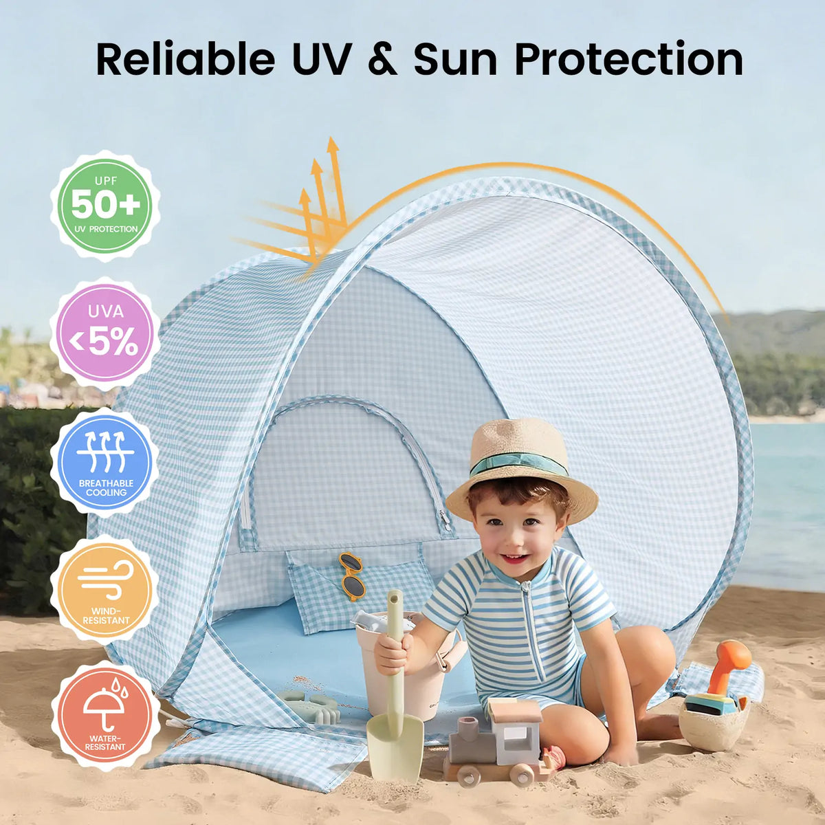 A young child in a sun hat plays with the Tiny Land® One-Stop Beach Toy & Tent Set – Light Blue Gingham inside the UV-protective, breathable, and water-resistant tent on sand. Brand: Tiny Land.|Light Blue Gingham