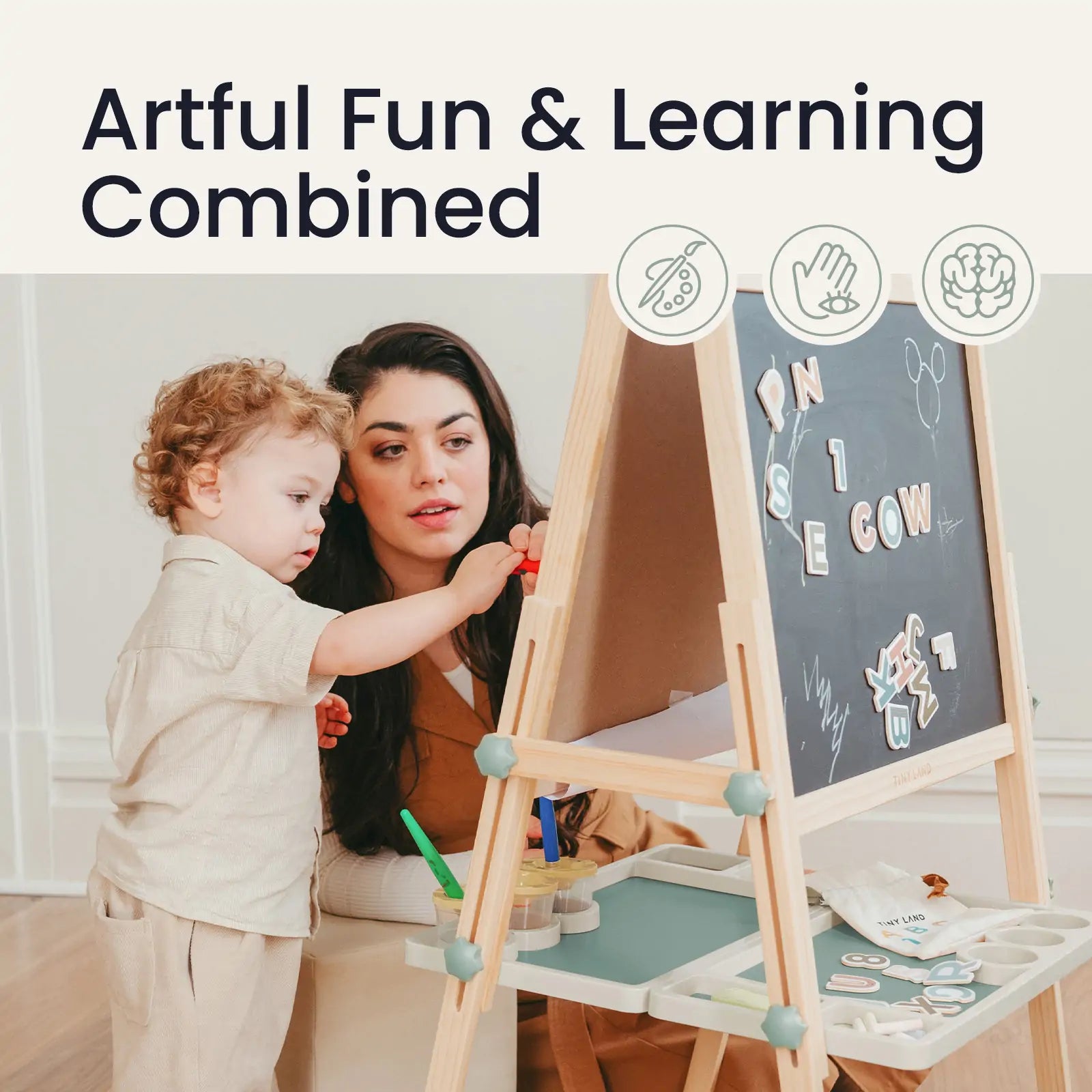 A woman and child play at a Tiny Land® Magnitales Easel for Kids - Green, using colorful magnets and art supplies. Text above: Artful Fun & Learning Combined, with three icons depicting creativity and learning. Brand: Tiny Land.