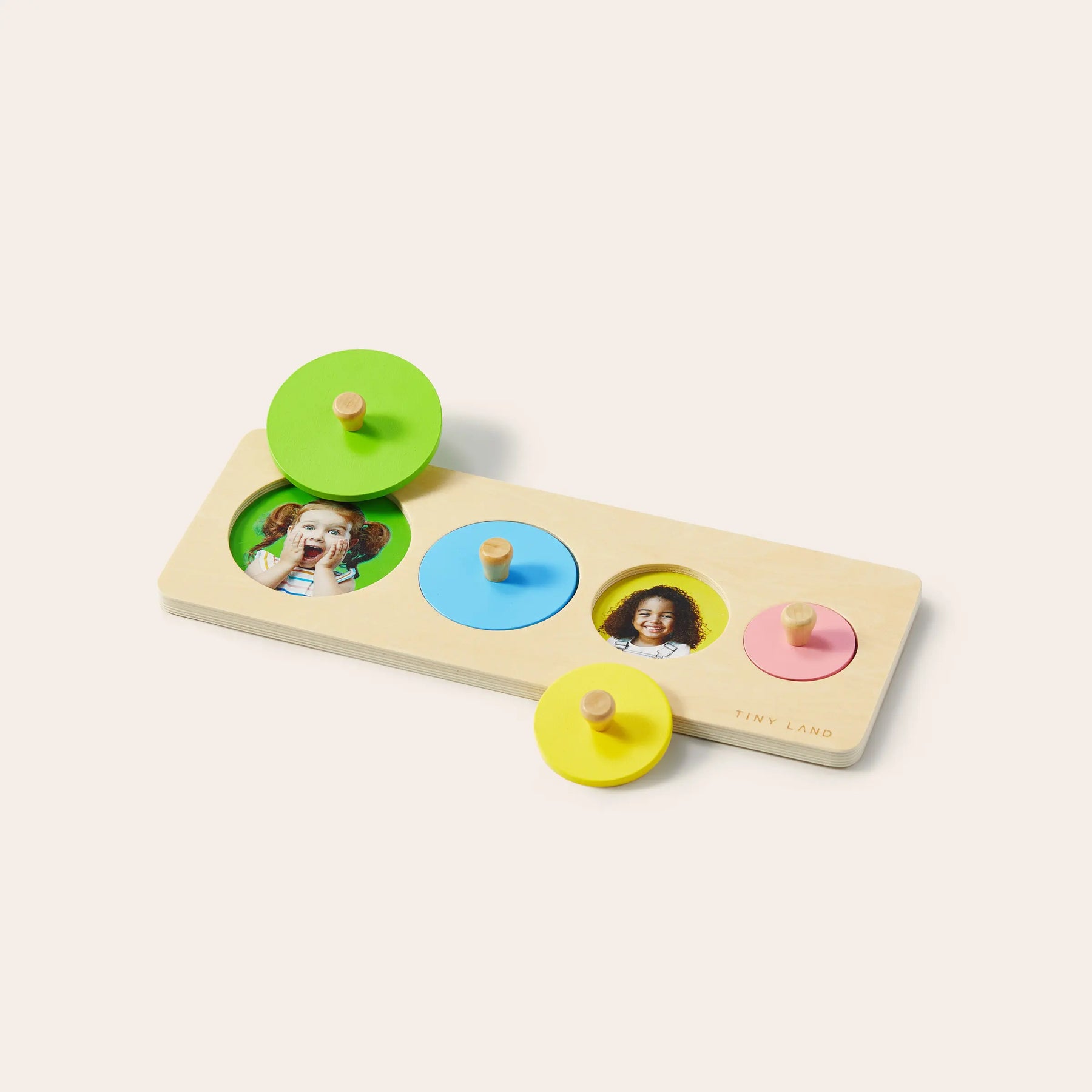 The Tiny Land® Montessori Toys for Toddlers (13–15 Months) by Tiny Land is a wooden puzzle board with three colorful knobbed pieces, designed to boost matching and motor skills in toddlers through fun and educational play.