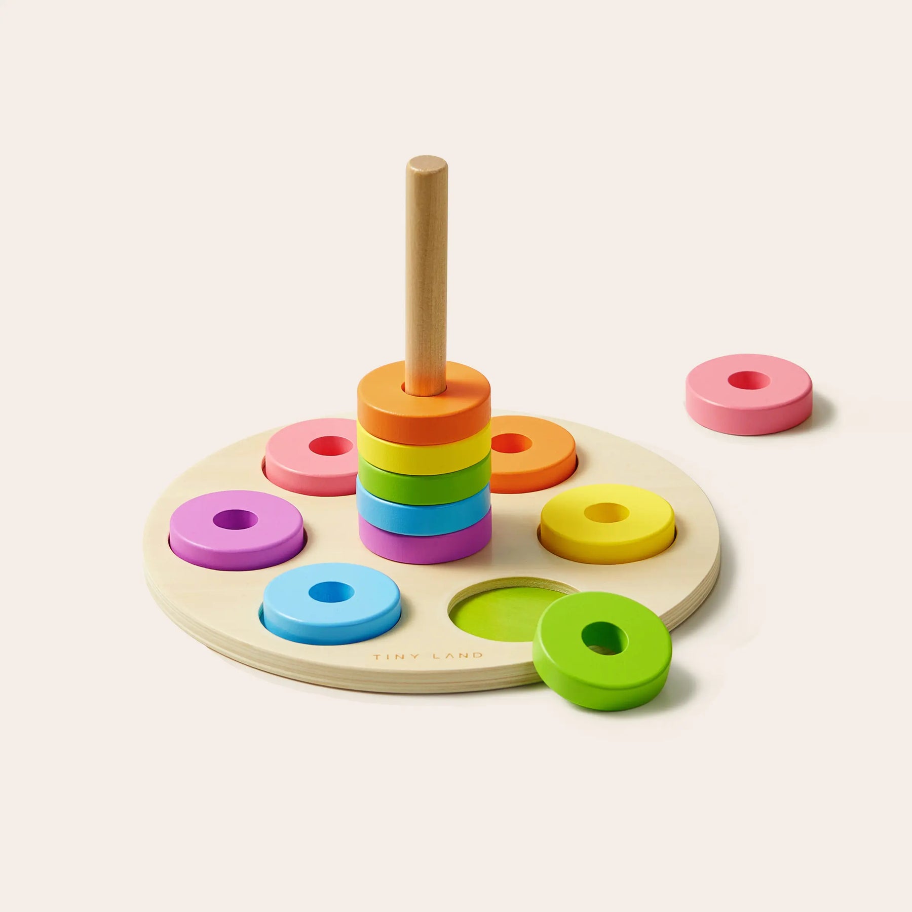 The Tiny Land® Montessori Toys for Toddlers (13–15 Months) by Tiny Land feature colorful stacking rings on a peg and circular base, making them ideal educational toys for early learning and engaging Montessori box activities.