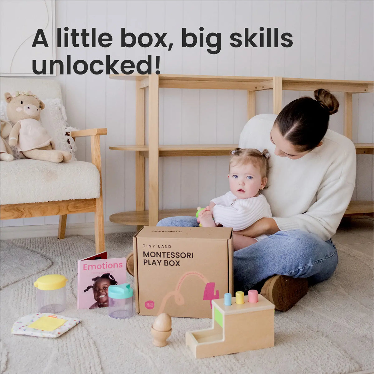 A woman and her baby play with Tiny Land® Montessori Toys for Infants (10–12 Months) from a box. The cozy room includes a chair, shelves, and plush toy. Text: Big skills begin with Tiny Land baby development toys!.