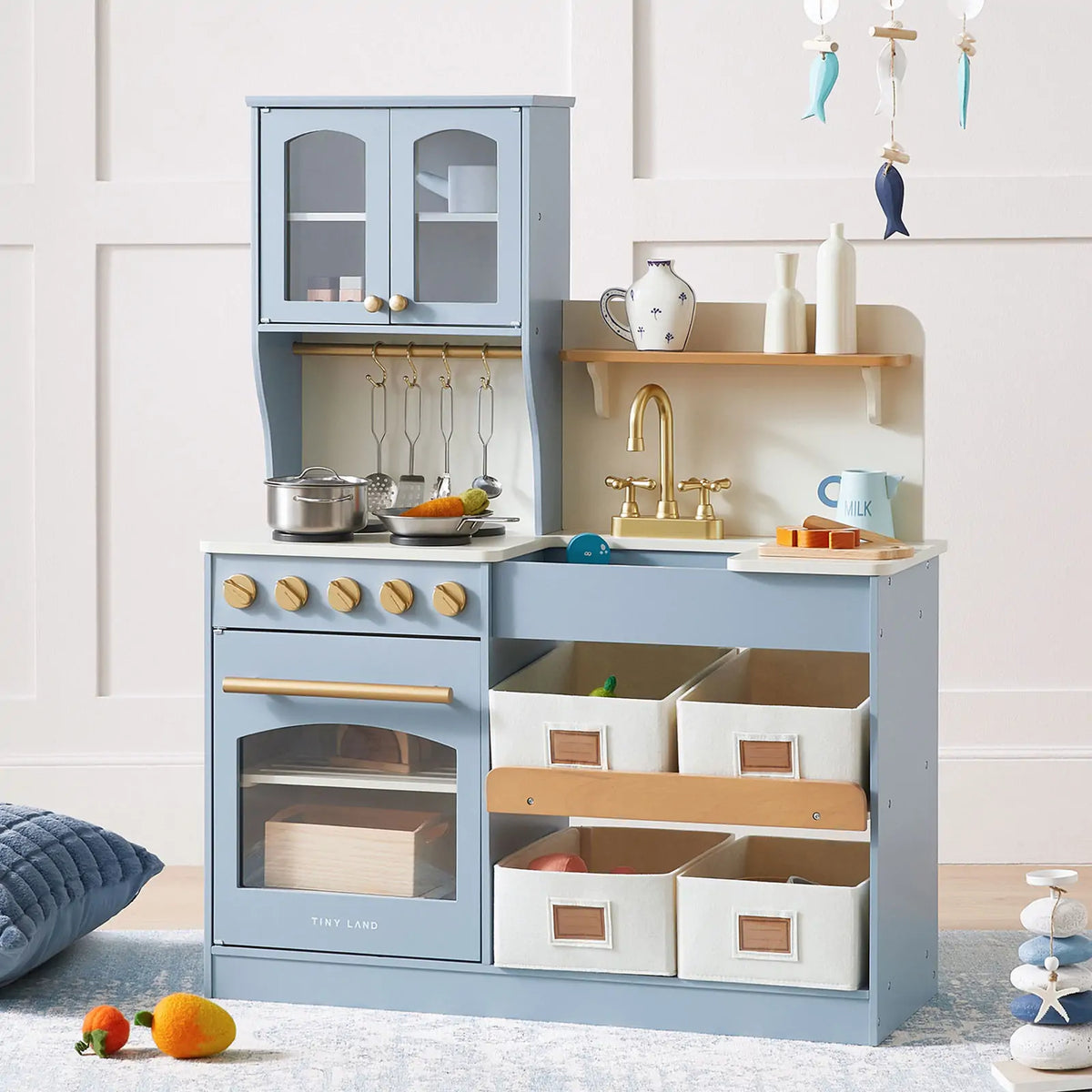 The Tiny Land® Pretend Play Kitchen for Kids - Serenity Wooden Kitchen in blue features a pretend oven, stove, gold faucet sink, storage bins, and cookware. This multifunctional set by Tiny Land is perfect for imaginative play.