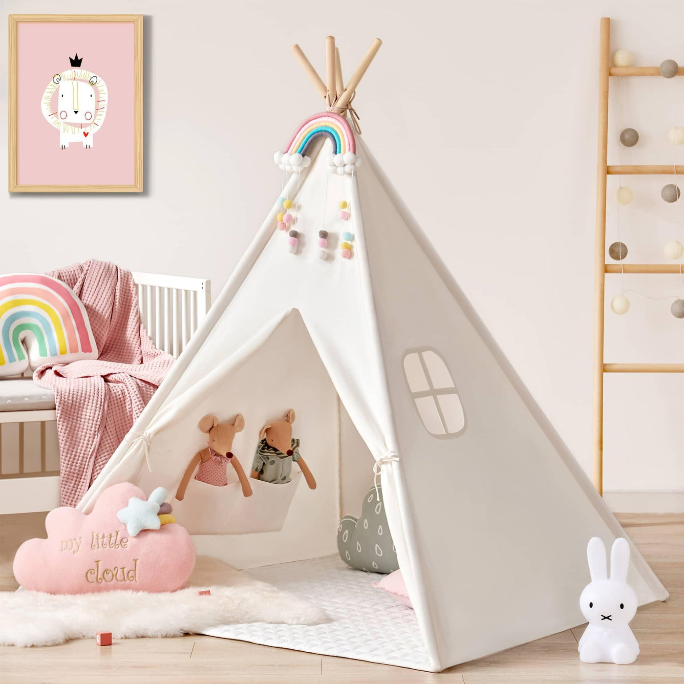 A cozy playroom features the Tiny Land Vibrant Imaginative Retreat Set— a colorful easel and kids teepee— accented with rainbow decor, pom-poms, stuffed animals, pastel cushions, and playful accessories against a light pink wall.