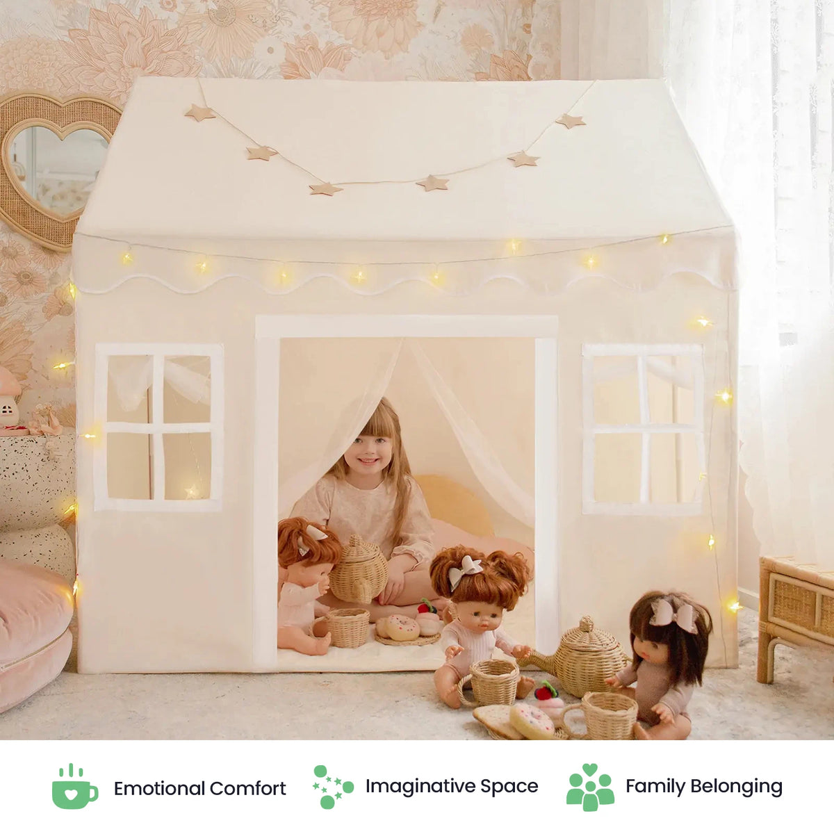 A young girl relaxes inside the Tiny Land® Playhouse Tent – Indoor Tent for Kids by Tiny Land, surrounded by dolls and picnic baskets in a gently illuminated, beautifully decorated room. Three icons below highlight: Emotional Comfort, Imaginative Space, Family Belonging.|white
