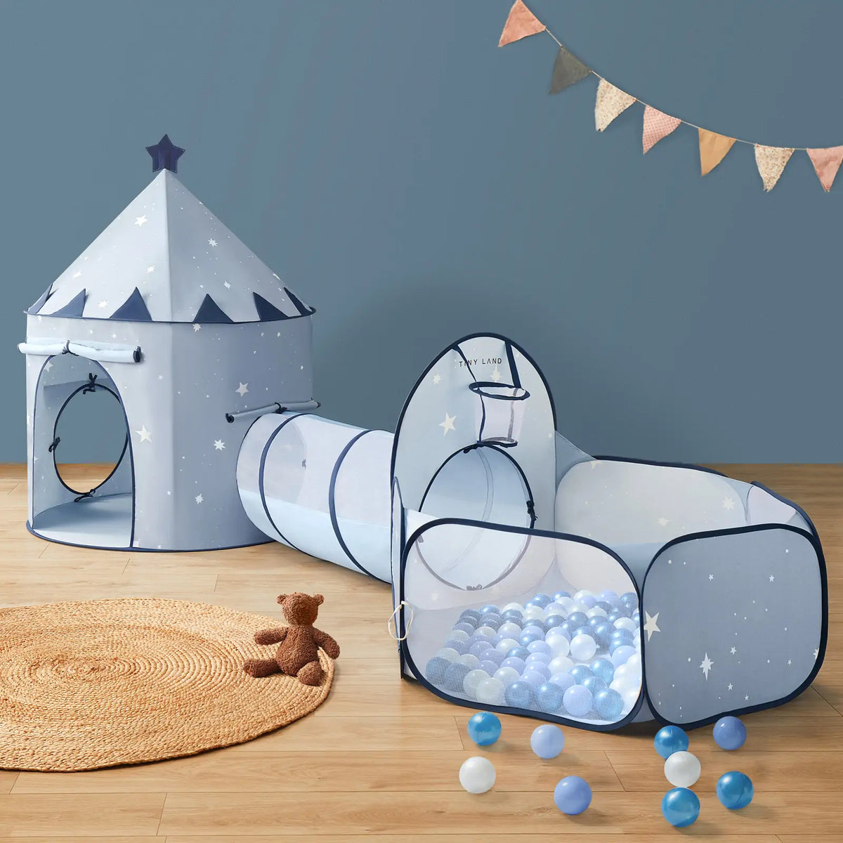 The Tiny Land® Compact Adventure 3-in-1 Play Tunnel in blue features a castle-shaped tent with star patterns, a connectable tunnel, and a ball pit (balls not included), all from Tiny Land—a perfect play space for kids.