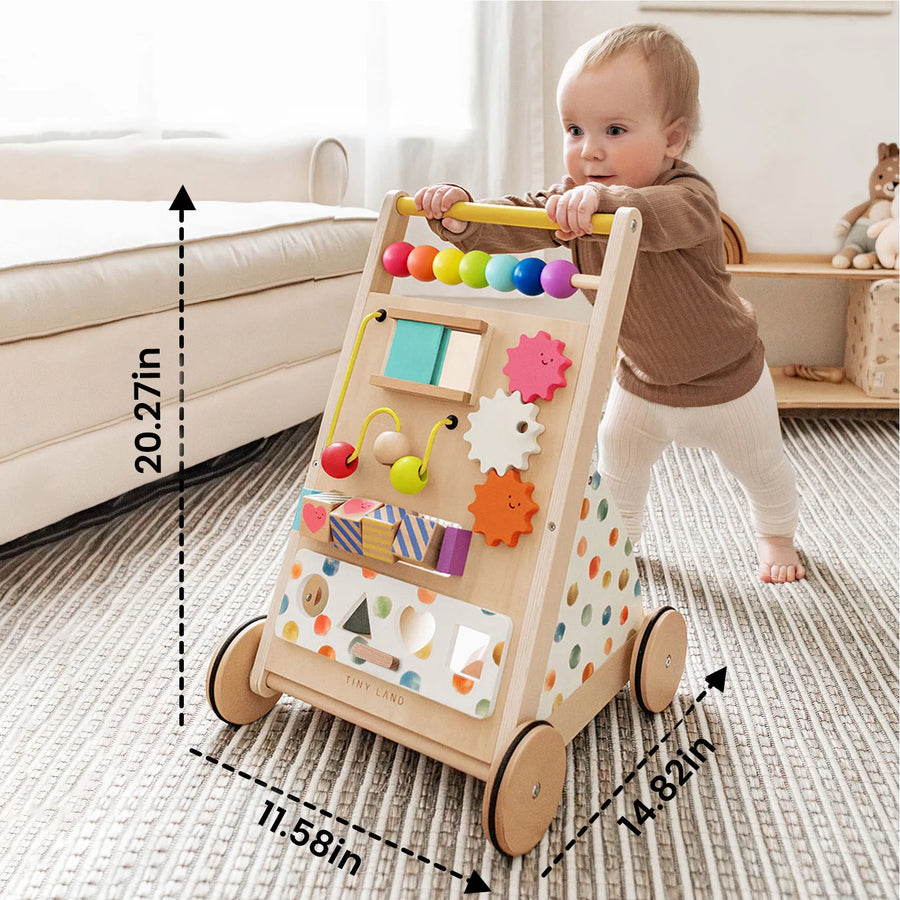 A baby stands, pushing the Tiny Land® Premium Natural Wooden Activity Walker by Tiny Land—a colorful wooden walker on wheels, equipped with engaging beads, gears, and developmental play items. Dashed lines display its dimensions: 20.27 inches tall, 11.58 inches wide, and 14.82 inches deep. This eco-friendly activity walker is thoughtfully designed to stimulate little ones with fun activities while promoting mobility and early learning.