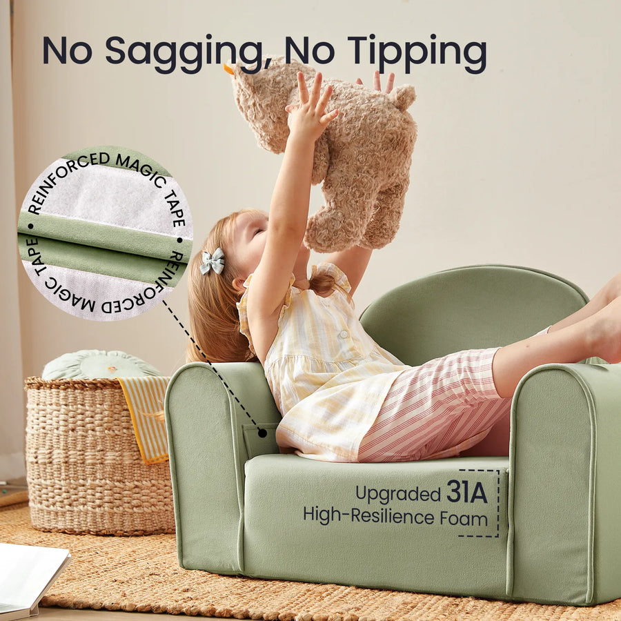 A young child plays with a stuffed bear while sitting on the Tiny Land® GentleSnug Kid Chair in light green—a perfect addition to any playroom. The text highlights key features such as No Sagging, No Tipping, secure magic tape closure, and upgraded 31A high-resilience foam. A woven basket sits in the background.|Sage