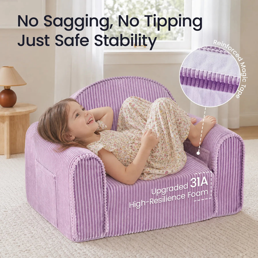 A young child in a floral dress lounges on the Tiny Land® GentleSnug Corduroy Kid Chair, an easy-to-clean purple chair from Tiny Land. Text highlights its sturdy design with magic tape reinforcement and upgraded 31A high-resilience foam for lasting comfort. A lamp and table are visible in the background.|Purple