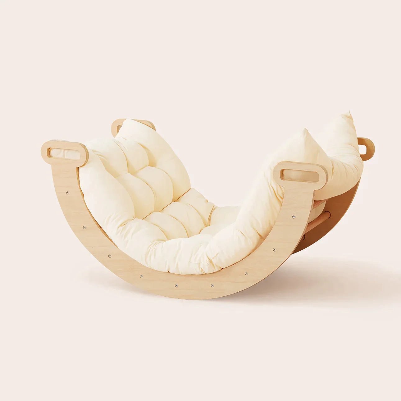 A wooden, crescent-moon-shaped rocking lounge chair with cream tufted cushions—ideal to pair with the Tiny Land® 7-in-1 Montessori Climbing Set with Play Pad for a cozy, playful corner.