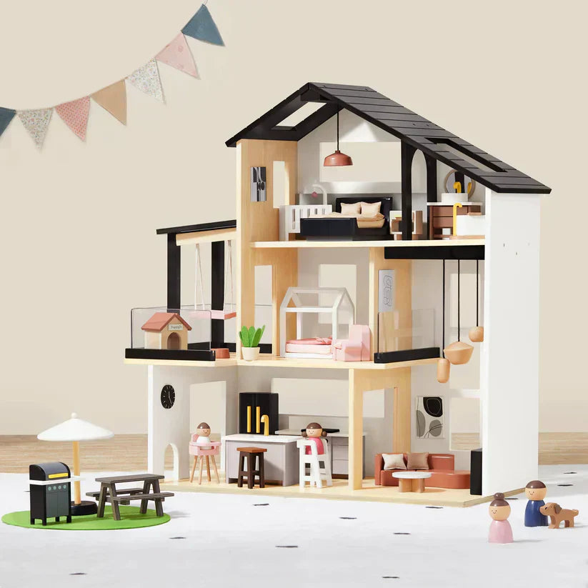 A black dollhouse with all its accessories neatly arranged inside.