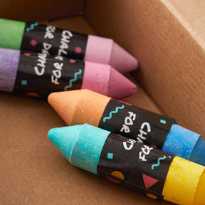 Four vibrant pieces of chalk—green, purple, pink, and blue—come in a box with each labeled "chalk for days." Perfect as an accessory for the Tiny Land® Magnitales Easel Art Kit by Tiny Land.