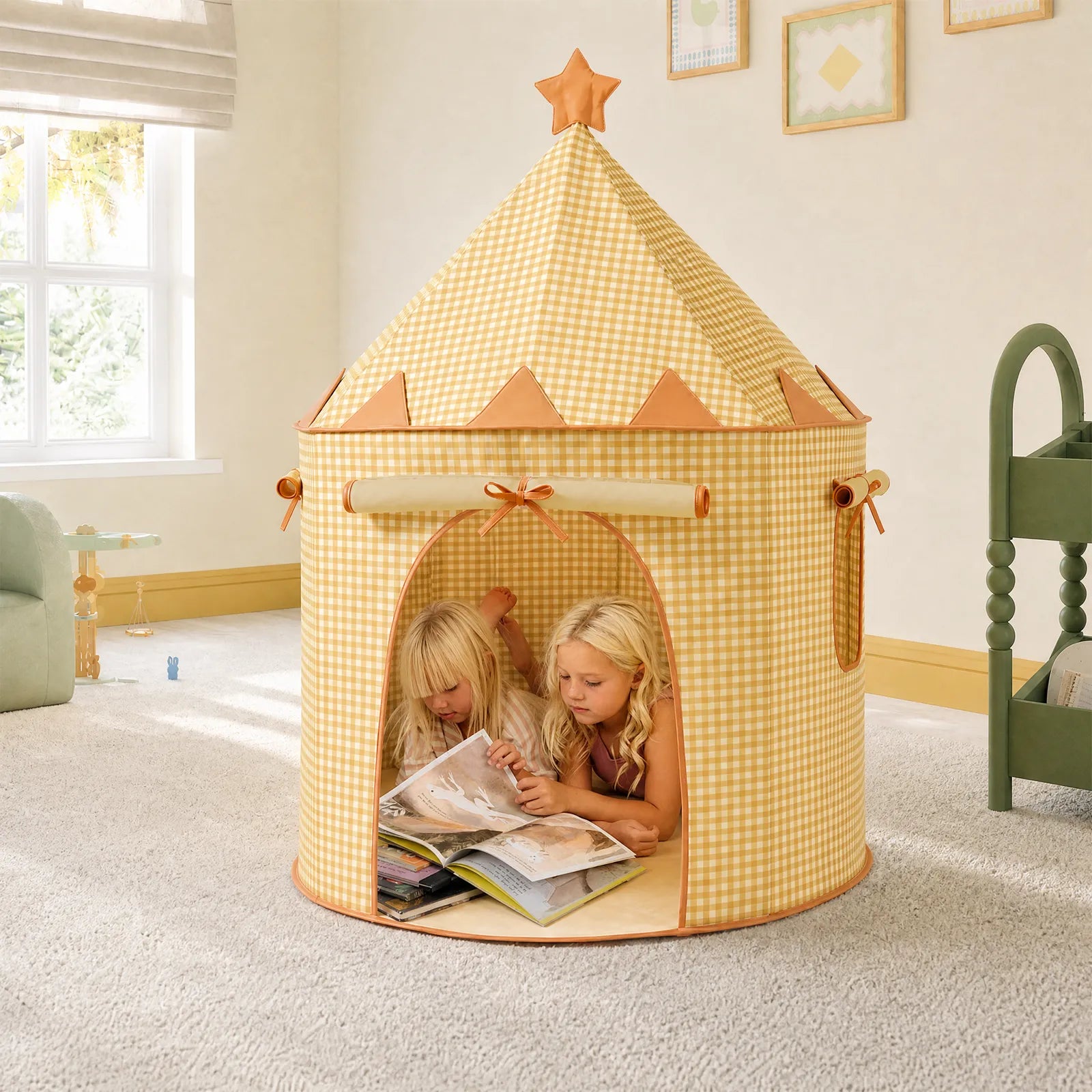 Two children read books together inside a Tiny Land® Kids Tent by Tiny Land INC, lying on their stomachs in a bright, cozy carpeted room filled with soft natural light.