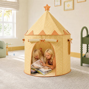 Two children read books together inside a Tiny Land® Kids Tent by Tiny Land INC, lying on their stomachs in a bright, cozy carpeted room filled with soft natural light.