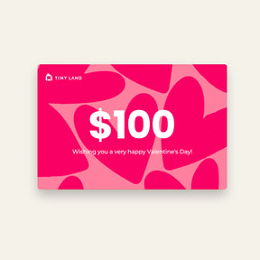 A $100 Tiny Land® Gift Card from Tiny Land featuring a pink and red heart background and the message "Wishing you a very happy Valentines Day!" in white text. Perfect as an online gift for someone special!.