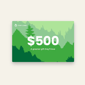 A $500 Tiny Land® Gift Card from Tiny Land, featuring layered green trees and mountain illustrations with "A greener gift they'll love" in white—an ideal online gift card for any occasion.
