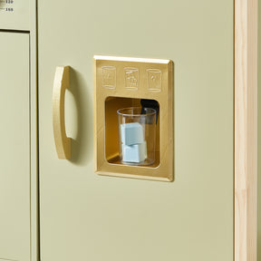 A clear cup with blue ice cubes sits in a gold dispenser on the light green cabinet of the Tiny Land® PopJoy Play Kitchen - Pink / Green, perfectly designed for pretend play, with icons above for water, ice, and crushed ice.|Sage