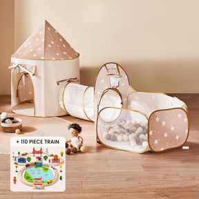 The Tiny Land Motion & Mind Playset features a beige and white star-patterned 3-in-1 play tunnel with balls, a ball pit, and an included stuffed doll. Also shown is its colorful 110-piece wooden train set.