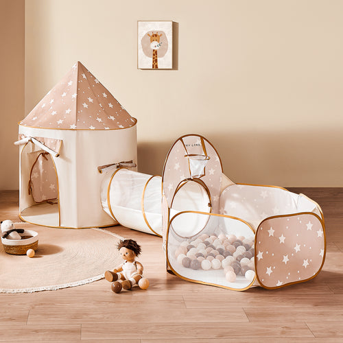 The Tiny Land® Adventure 3-in-1 Play Tunnel & Ocean Ball Set features a beige and white star-print tent, matching tunnel, and mesh ball pit with pastel balls, all set atop a round rug with plush toys and a cute giraffe print on the wall.