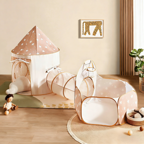 The Tiny Land® Compact Adventure 3-in-1 Play Tunnel sits on a wooden floor surrounded by toys, a plush doll, and soft balls, while a giraffe print decorates the wall. Note: Balls are not included with this Tiny Land product.