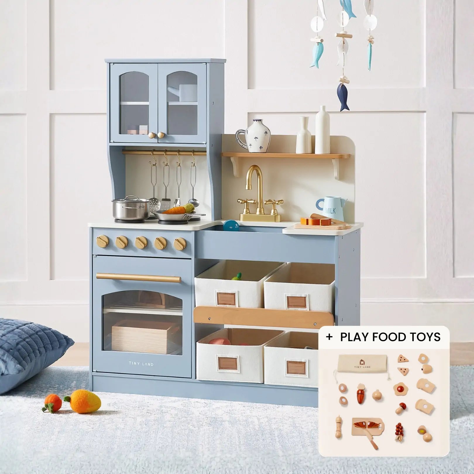 The Tiny Land® Smart Storage Kitchen Cooking Set by Tiny Land is a blue and white wooden play kitchen featuring toy appliances, shelves, utensils, storage bins, and assorted play food toys with a wooden coffee maker set.