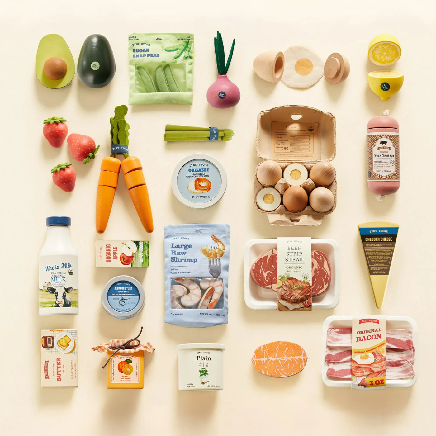 The Tiny Land® Organic Play Food Collection features wooden toys—vegetables, fruits, milk, eggs, cheese, seafood, bacon, meat, yogurt, juice & packaged goods—each crafted to look like real groceries for realistic pretend play.