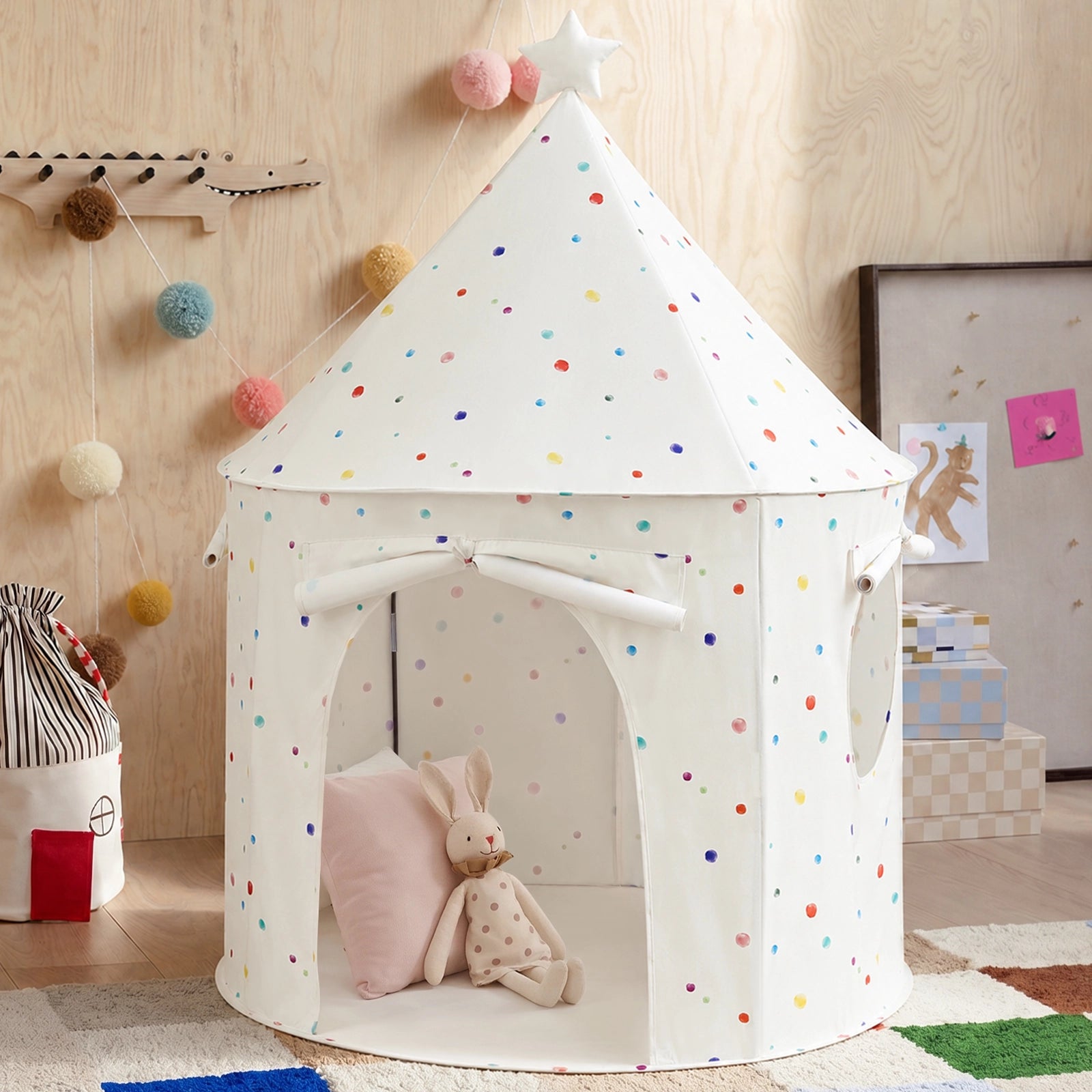 Tiny Land® Kids Tent, a white conical indoor play tent with colorful polka dots, featuring a stuffed rabbit and a pillow inside to create a cozy reading nook.|Colorful Dots