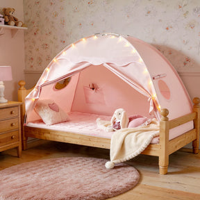 The Tiny Land® Kids Bed Tent by Tiny Land creates a playful hideaway with its pink canopy, string lights, heart pillow, and plush bunny. Its wooden frame sits by floral wallpaper, a pink rug, and a wooden nightstand with lamp.|Pink
