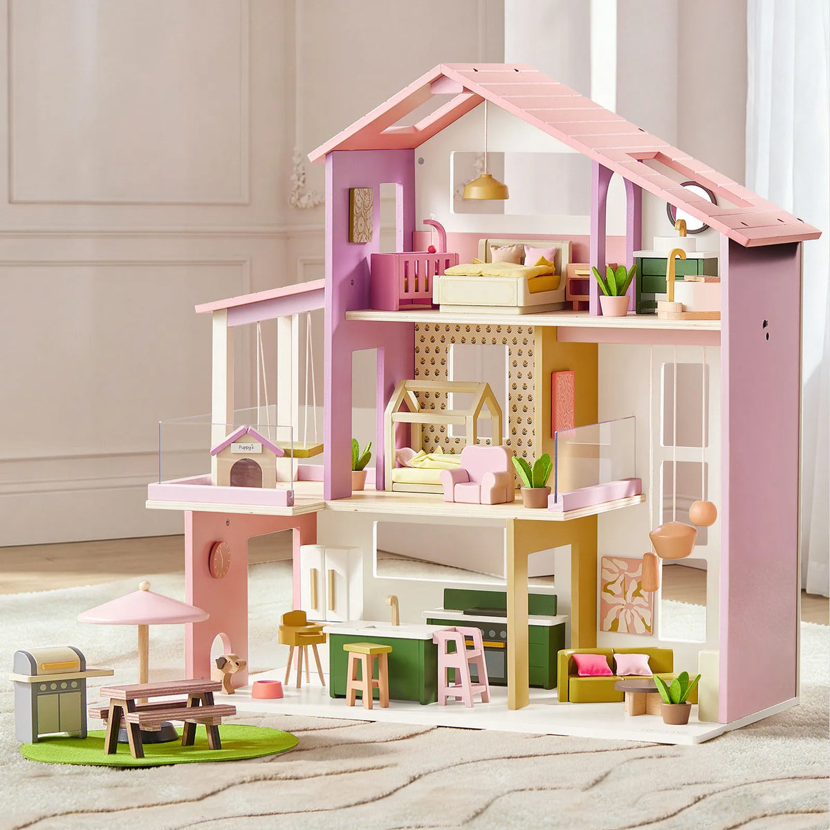 Introducing the Tiny Land® Sweetwood Edge Dollhouse - Green & Pink by Tiny Land, a vibrant wooden dollhouse with three floors. It comes complete with charming wooden dollhouse furniture, including a kitchen, bedroom, bathroom, and balcony. Kids will also love the outdoor play area equipped with a grill, table, and umbrella. Accented in pastel pink and green tones, this delightful dollhouse doubles as a Montessori toy designed to spark imaginative play and creativity.|Pink