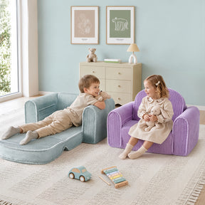 Two young children—a boy relaxing on a blue lounger and a girl seated on the Tiny Land® GentleSnug Corduroy Kid Chair by Tiny Land—play with stuffed animals in a softly decorated room filled with toys, art, and pastel-hued corduroy furniture.|Purple