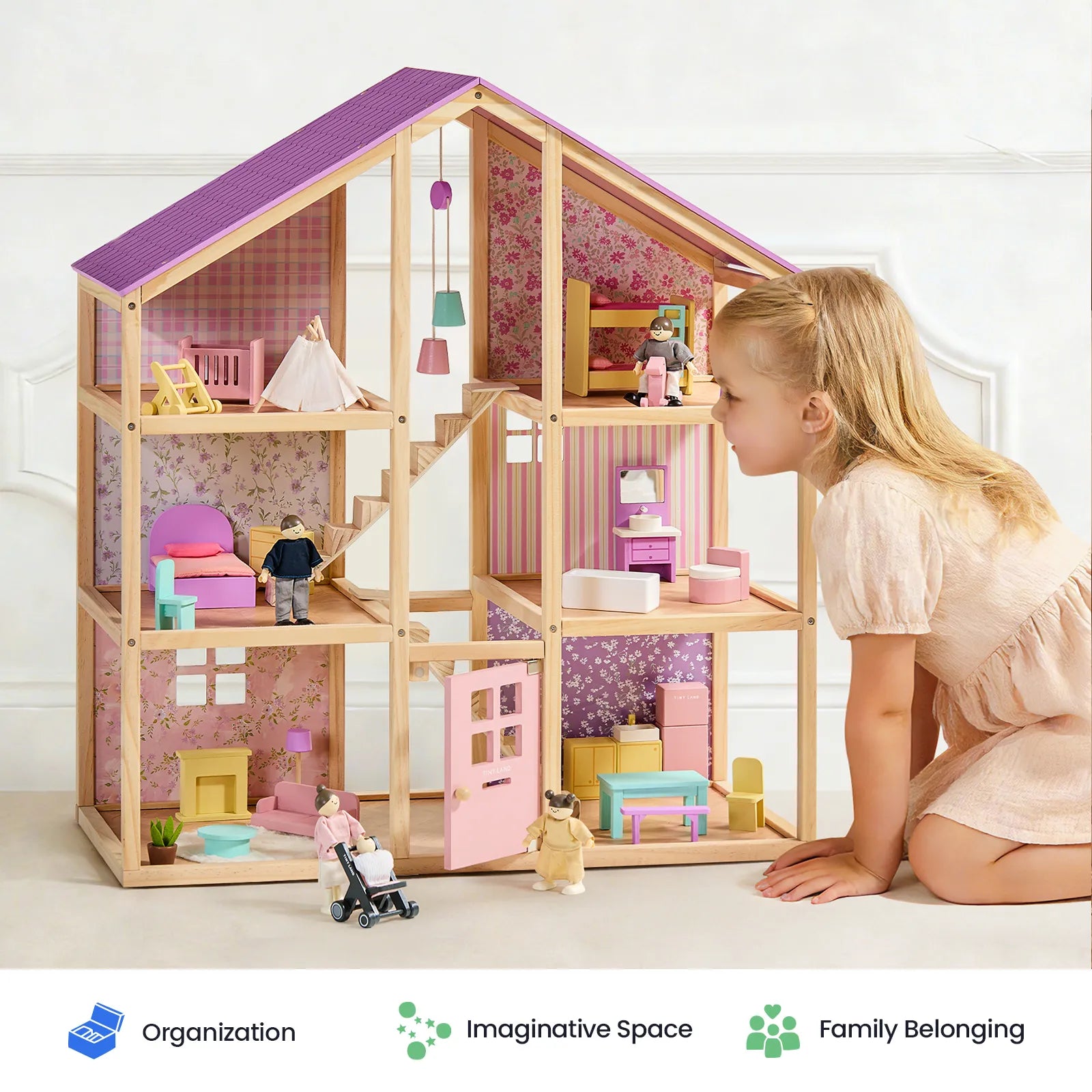 A young girl kneels by the Tiny Land® Sweetwood Dollhouse without Dolls from Tiny Land, a timeless wooden playset complete with charming furniture, smiling as she immerses herself in imaginative play. Three labeled icons below read: Organization, Imaginative Space, Family Belonging.|Unicorn