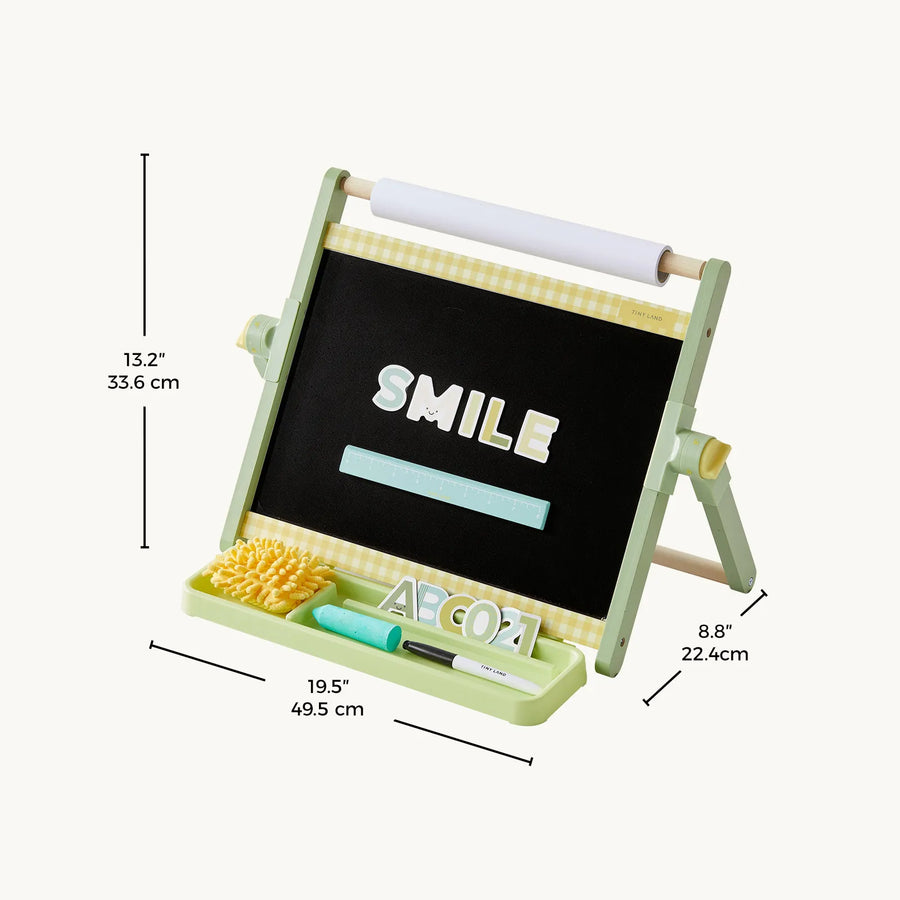 The Tiny Land® Double-Sided Magnetic Tabletop Easel by Tiny Land is a green tabletop art station that functions as an adjustable kids easel. It features a chalkboard and a magnetic whiteboard with colorful letters spelling "SMILE," plus a convenient paper roll on top. The tray holds chalk, an eraser, and other accessories for easy access. The dimensions are 13.2 inches high, 19.5 inches wide, and 8.8 inches deep.|Green